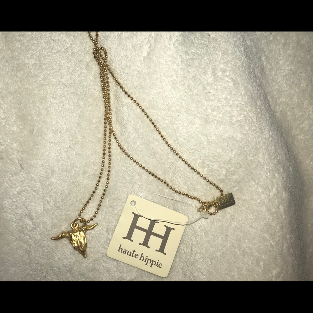 Gold cow skull necklace.
